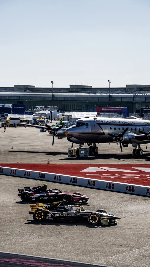 Formula E cars on the grid in front of the Tempelhof airport terminal