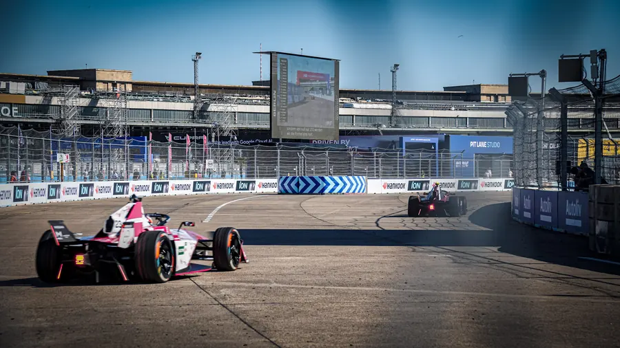 Pink Formula E car exiting a corner at Berlin Tempelhof