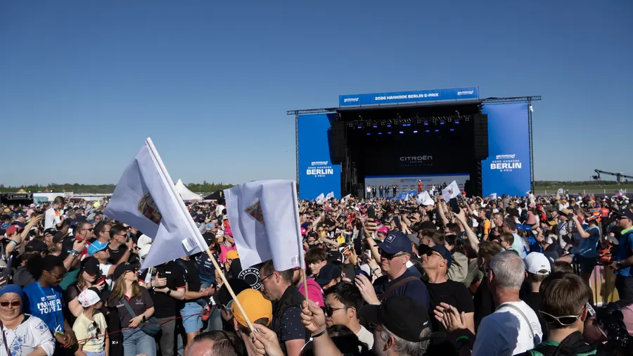 Fans with flags in front of the stage at the Berlin E-Prix fan village
