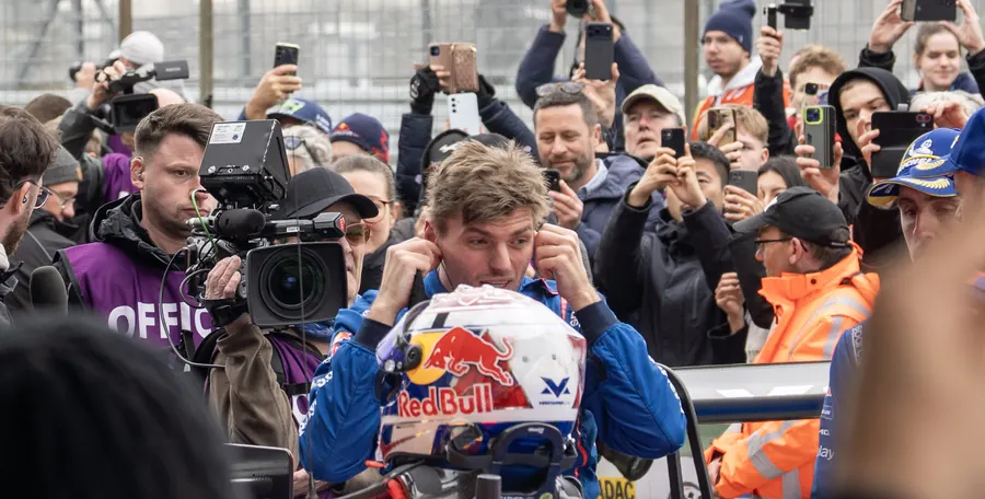 Max Verstappen with his helmet in the crowd of fans and cameras, Nürburgring