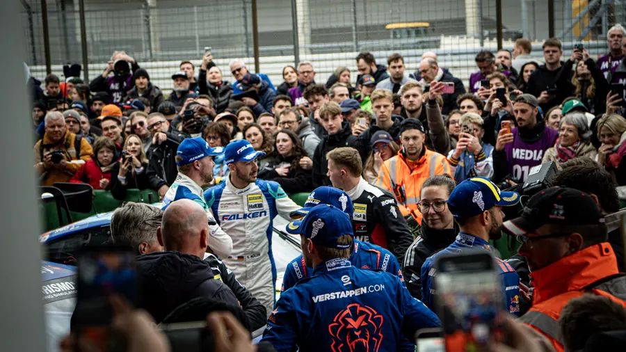Verstappen.com Racing crew in the packed pit lane at the Nürburgring